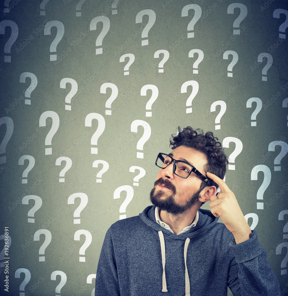 Thoughtful confused man has too many questions and no answer Thoughtful confused man has too many questions and no answer