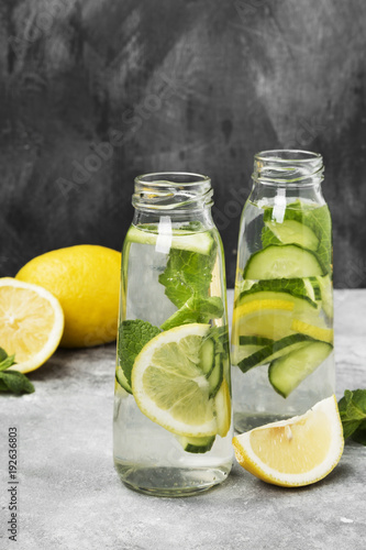 Detox drink with cucumber, lemon and mint on a gray background