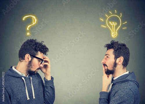 Two men thinking one has a question another solution with light bulb above head photo