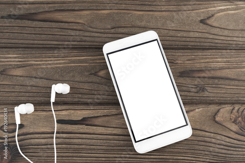 smartphone, headphones on a wooden background. music, radio, internet. technologies.