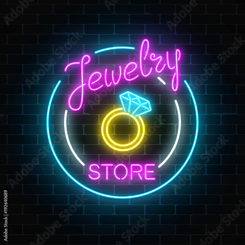 Jewelry store glowing neon signboard on dark brick wall background. Bijou shop advertisement shining sign.