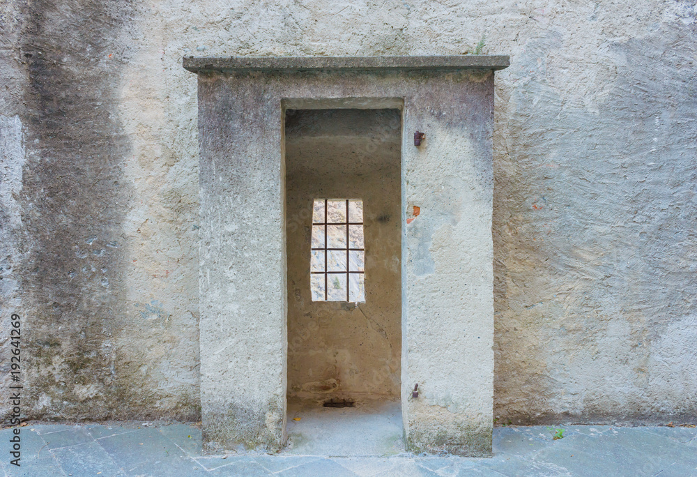 the sentinel room with the window with security grating of an ancient castle / detail of a the sentinel room with the window with security grating of an ancient castle