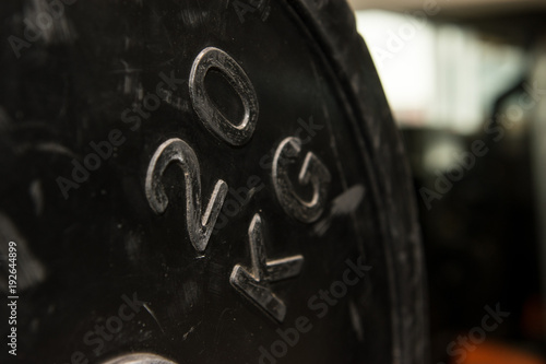 Twenty kilograms round weight in a gym. Workout equipment. photo