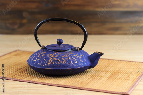 Blue Chinese cast iron teapot. Cooking utensils.