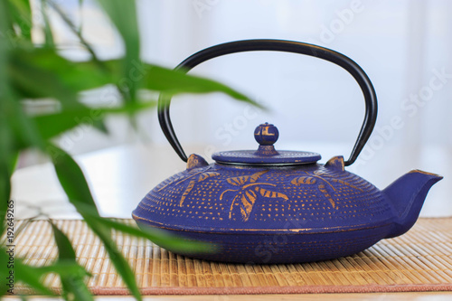 Blue Chinese cast iron teapot. Tea drinking.