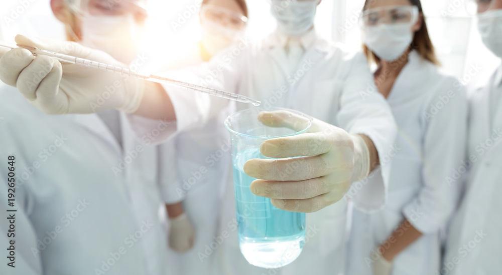 closeup of a group of medical workers working with liquids closeup of a group of medical workers working with liquids