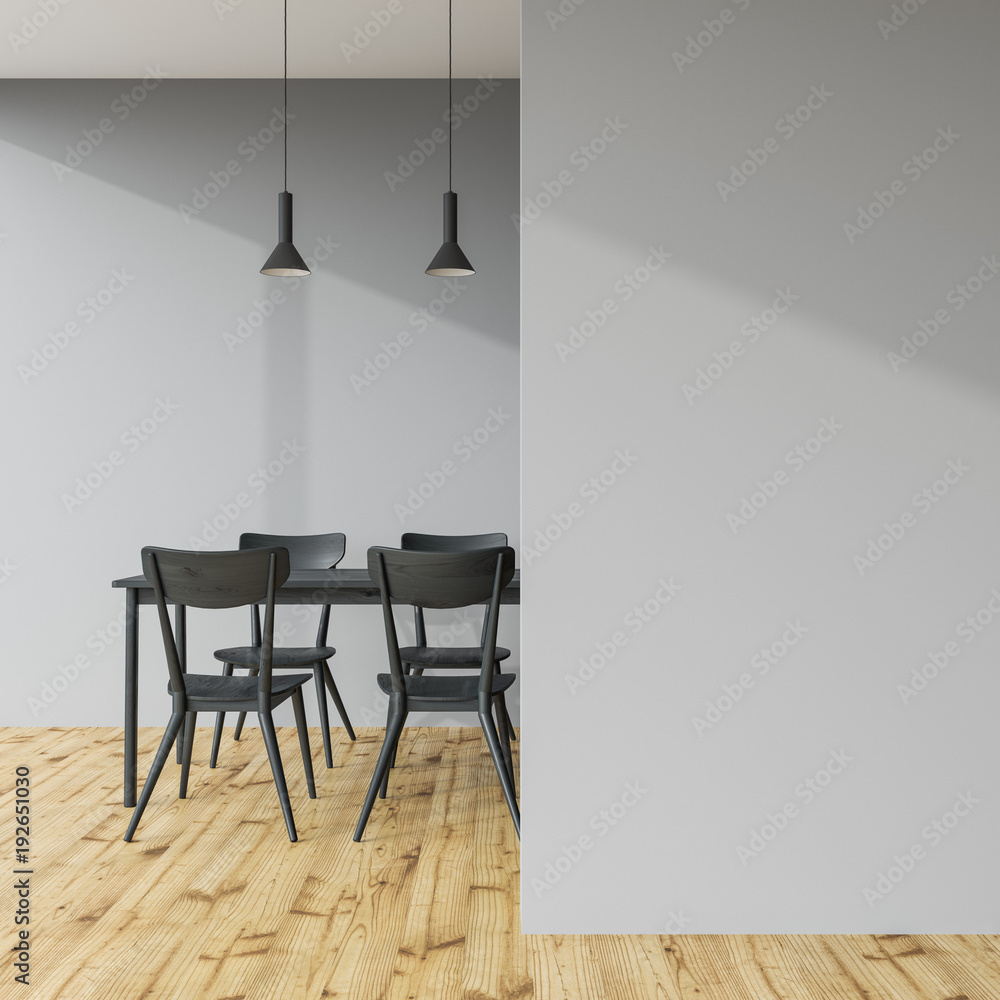 Fototapeta premium Dark gray dining table in a gray room, wall