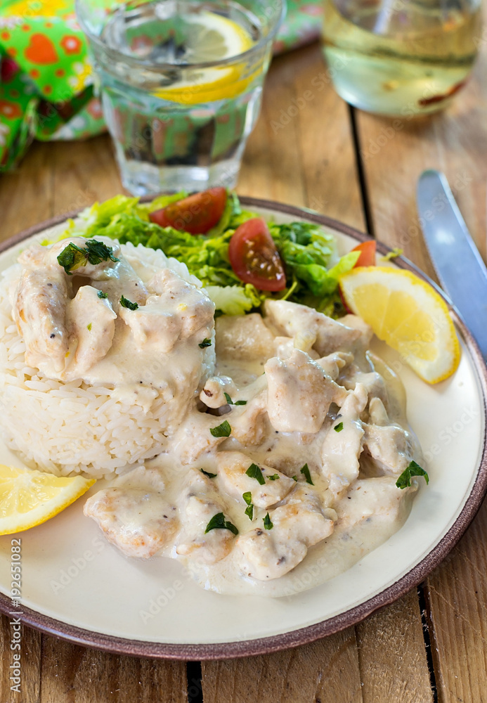 Chicken in cheesy creamy sauce served with rice Chicken in cheesy creamy sauce served with rice