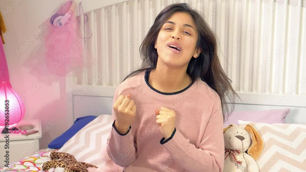Happy hispanic young woman dancing in bedroom slow motion closeup Happy hispanic young woman dancing in bedroom slow motion closeup