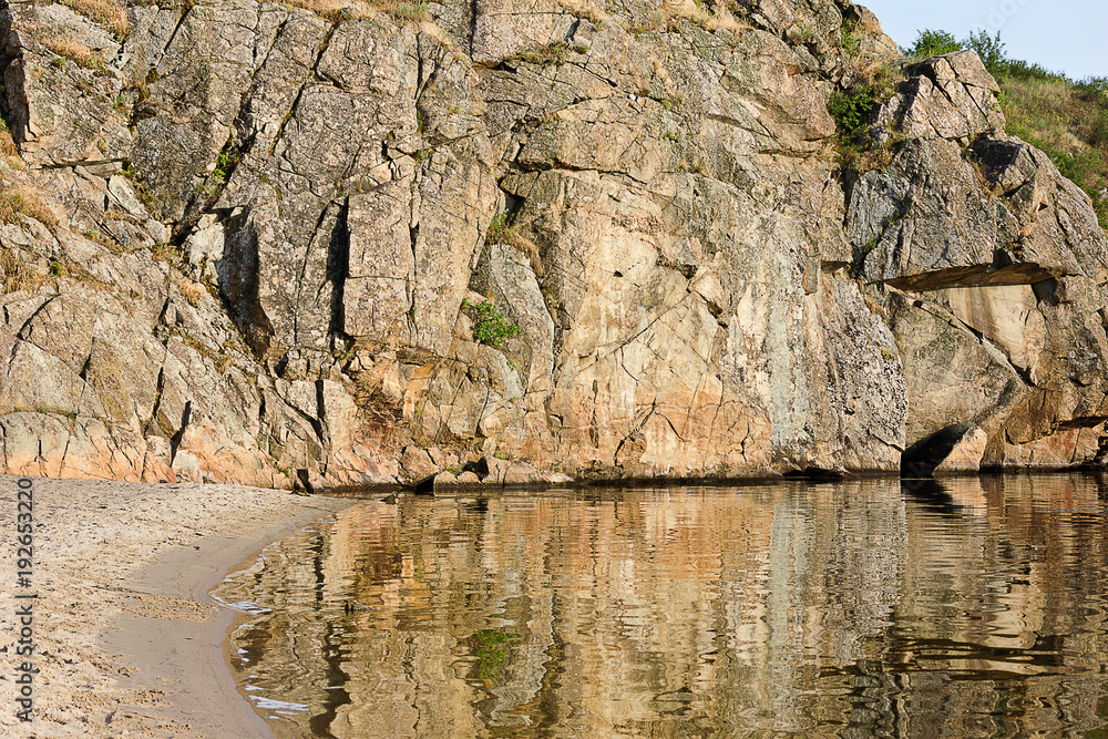 Beach and rock on the river bank