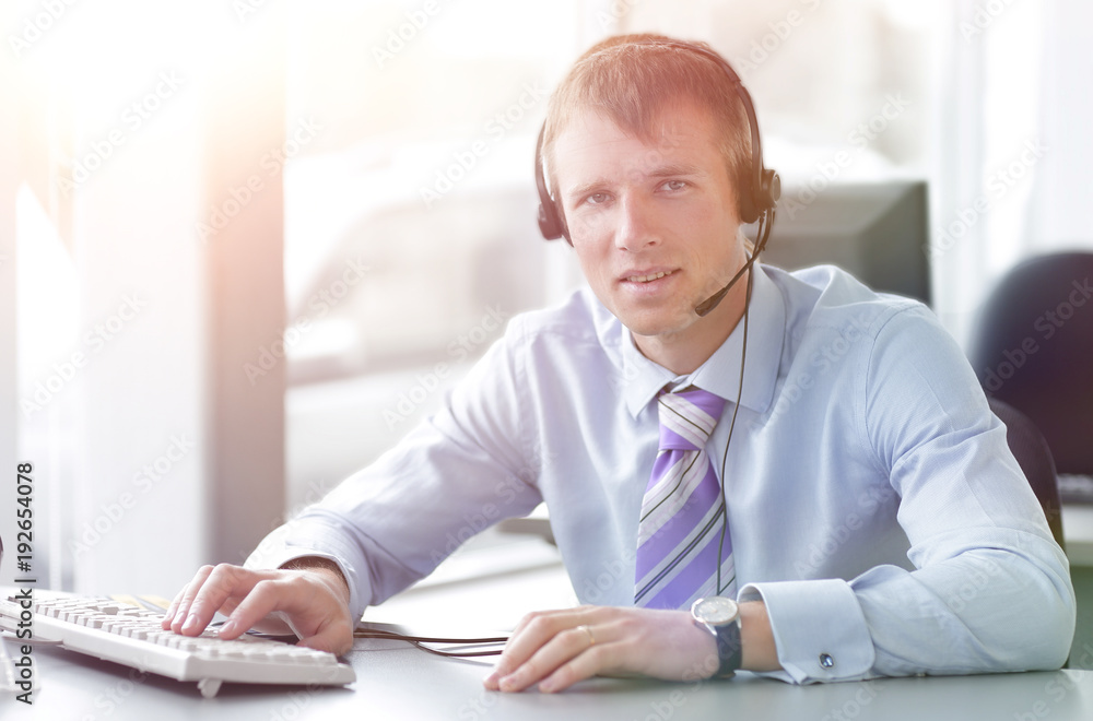 Naklejka premium Happy businessman in headphones smiling while looking at camera.