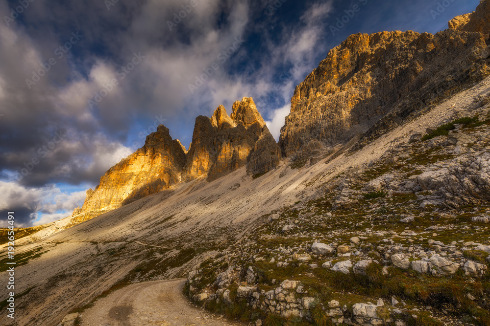 Hiking Trail in Tre Cime di Laveredo. Lake. Meadow. Green Grass. Summer. Blue Sky. Mountain Peak. Dolomites. Italy. Tre cime are one of the best-known mountain groups in the European Alps