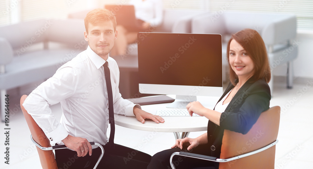 smiling member of the business team sitting at Desk smiling member of the business team sitting at Desk