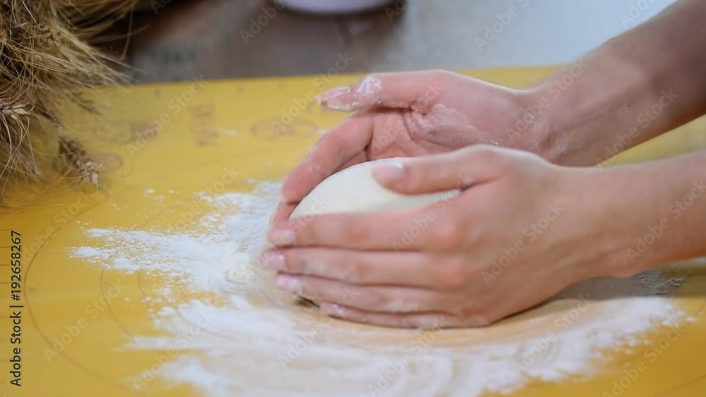 Making dough by female hands on table background Making dough by female hands on table background