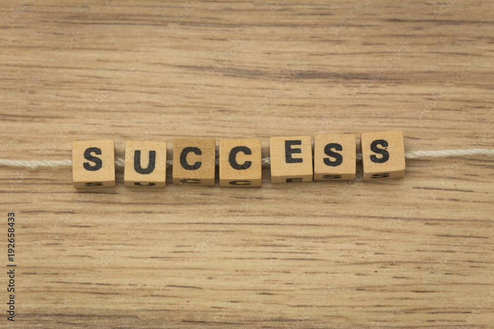 Fototapeta premium inscription / success / arranged from blocks strung on a string