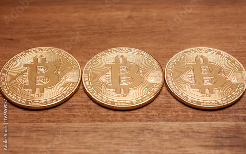 three golden bitcoin coins photo