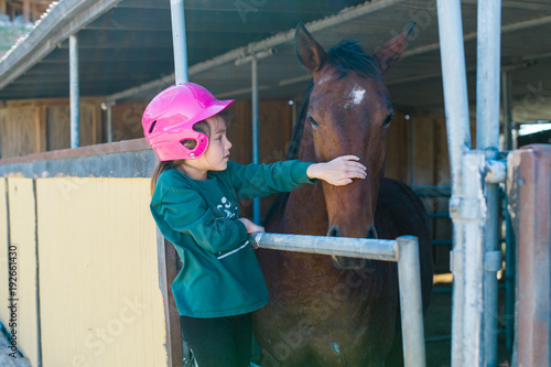 Girl petting horse