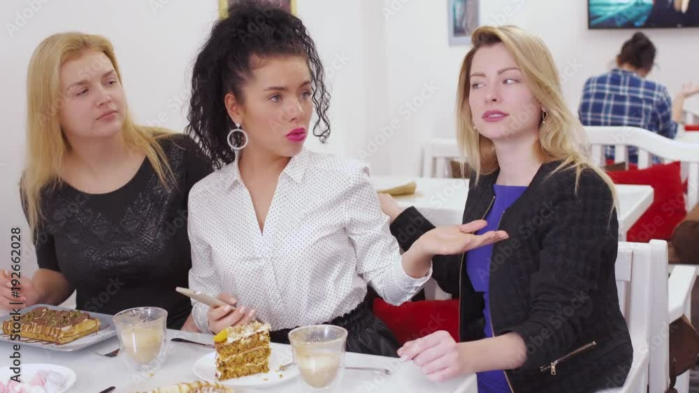 Young unhappy woman calls waiter in cafe and outraged due to poor service Young unhappy woman calls waiter in cafe and outraged due to poor service