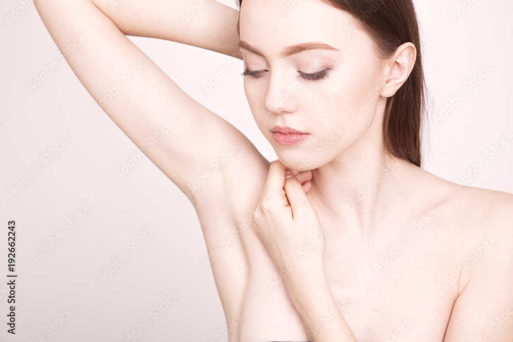 Close up young woman showing and touching her smooth axilla. Close up young woman showing and touching her smooth axilla.