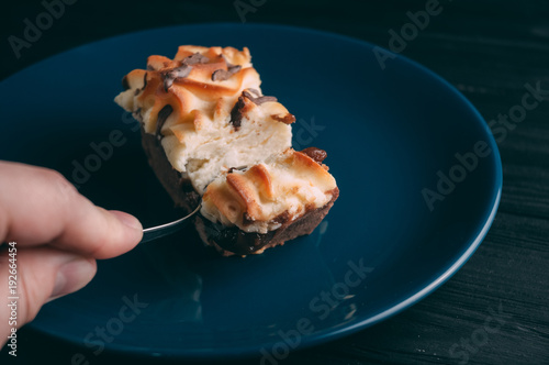 curd cake in a plate lies on a wooden background