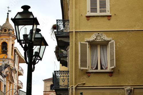 Street light in small italian city, window, facade and church