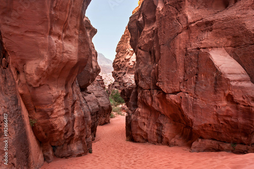Red stone walls of the canyon of Wadi Rum desert in Jordan. Wadi Rum also known as The Valley of the Moon is a valley cut into the sandstone and granite rock in southern Jordan to the east of Aqaba.