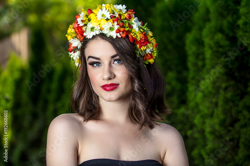 Beautiful woman in wreath of flowers