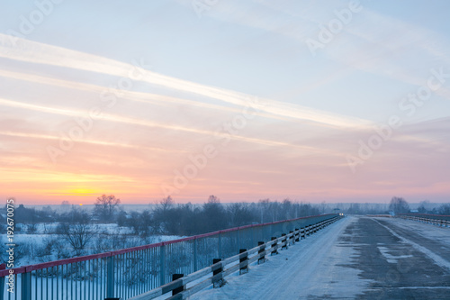 Road at sunset in winter. Snowy road at sunset. © Sergey_Siberia88