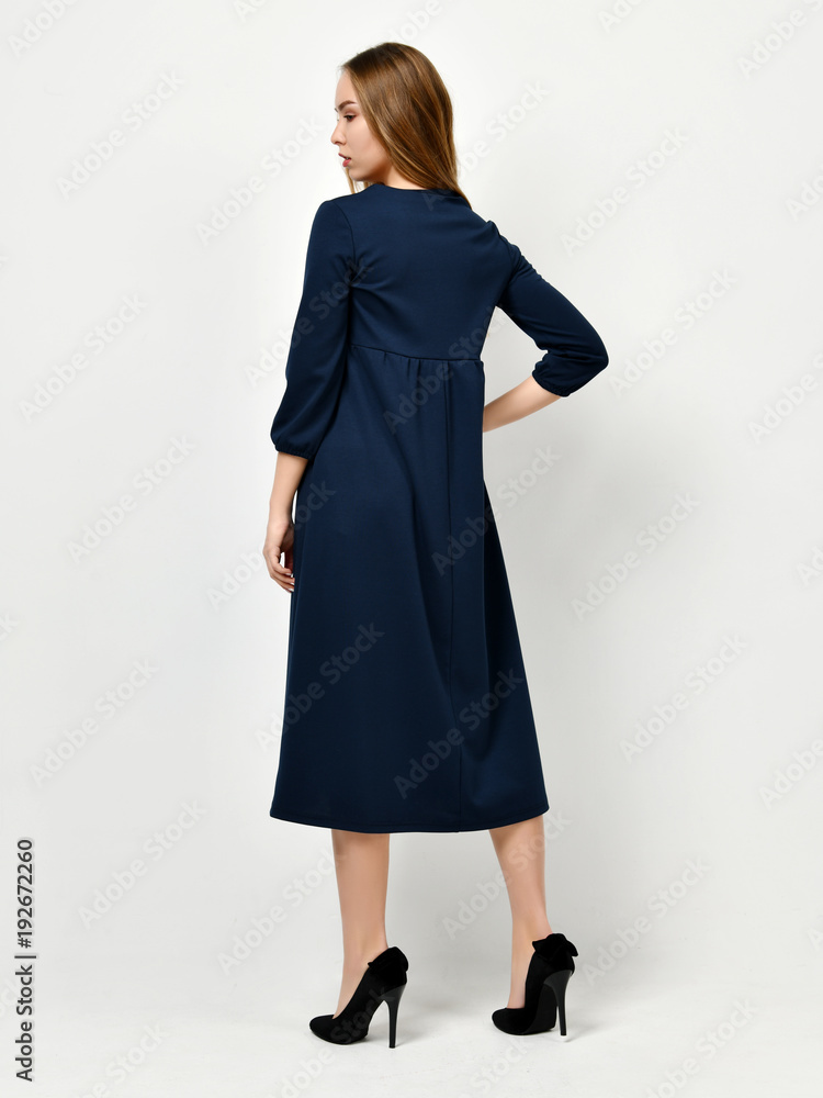 Young beautiful woman posing in new casual winter blue dress Young beautiful woman posing in new casual winter blue dress