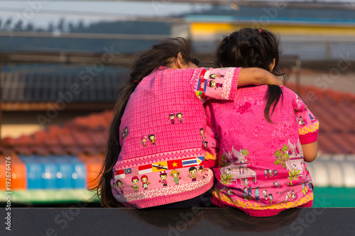 two asian little girls sitting toghter photo