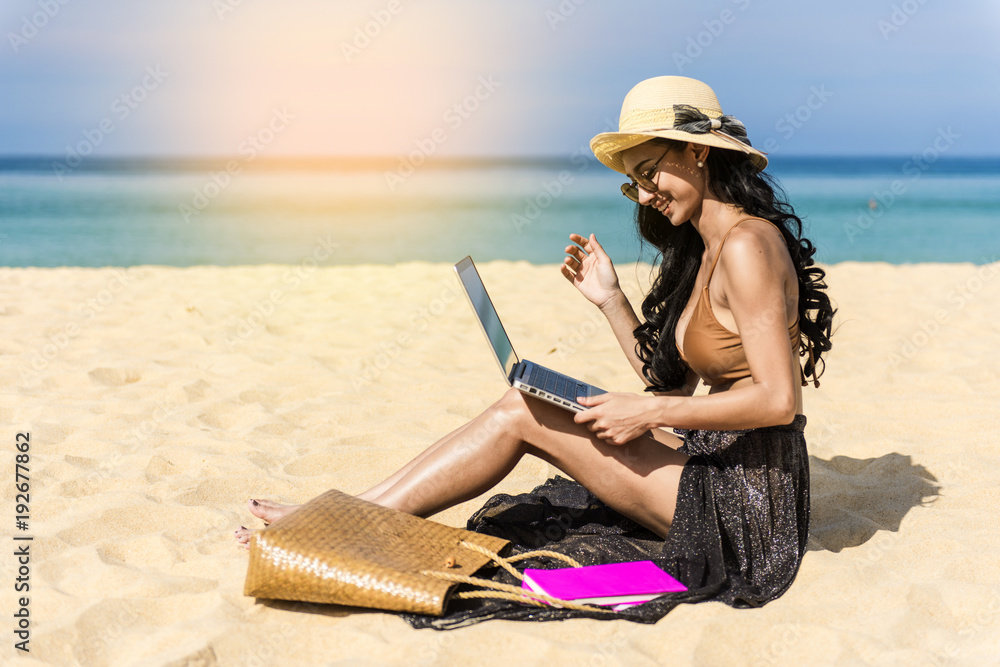 woman happy relax in vacation using laptop computer on the beach. Freelance work concep
