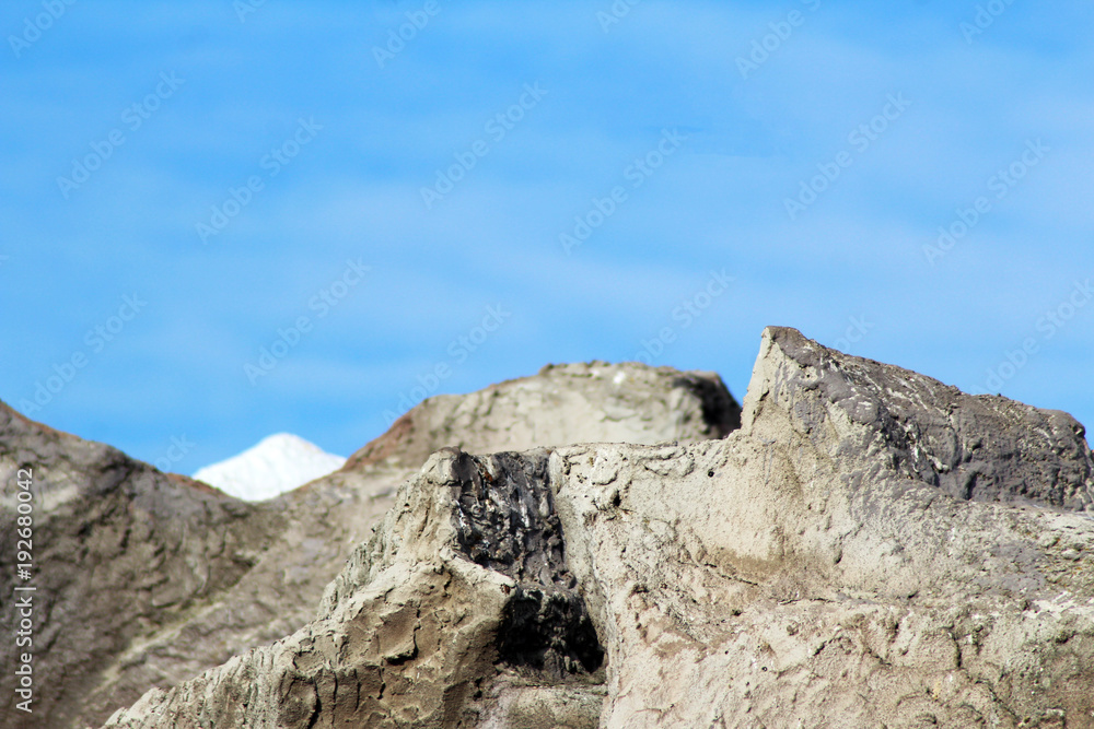 A rock wall against a blue sky.