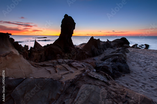 sunset seascape with beautiful rocks formation on the ground.