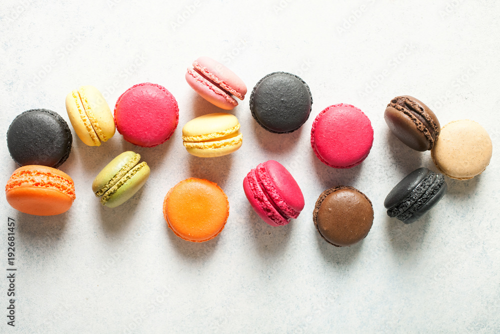 Different macaroons on a light background. Top view