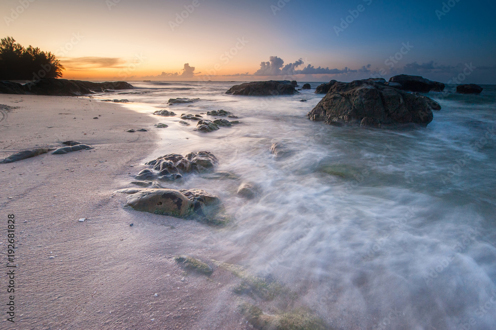vibrant sky suring sunset with waves trails. image content soft focus due to slow shutter.