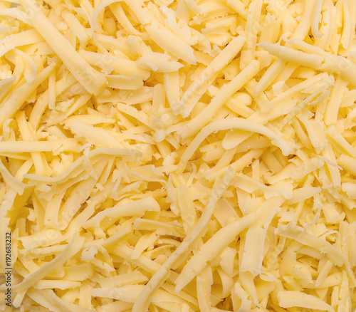 Grated cheese as food background. Top view.