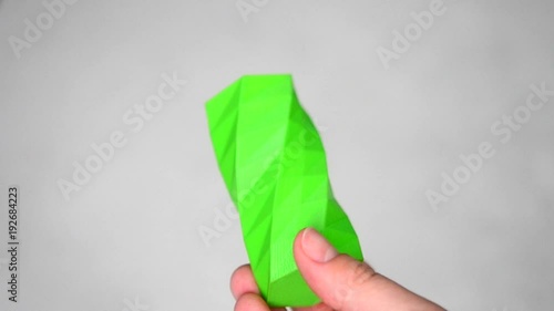 The person holds on his hands and view green object created on 3d printer. POV, point of view, mtb. Fused deposition modeling, FDM. Progressive modern 3D printing additive technology. 4ht revolution. photo