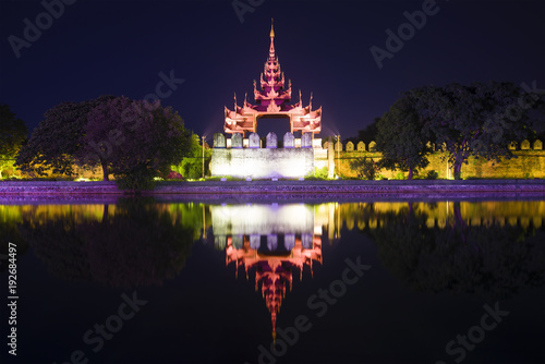 Defensive bastion with a tower in the night illumination. Mandalay, Myanmar (Burma)