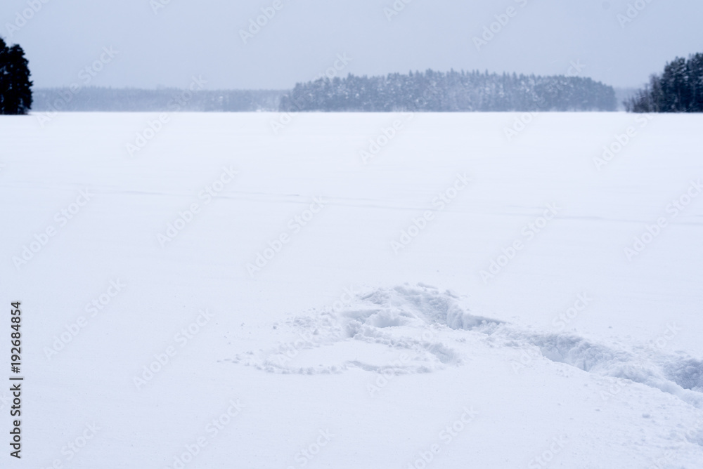 Heart shape on a snowy and frozen lake