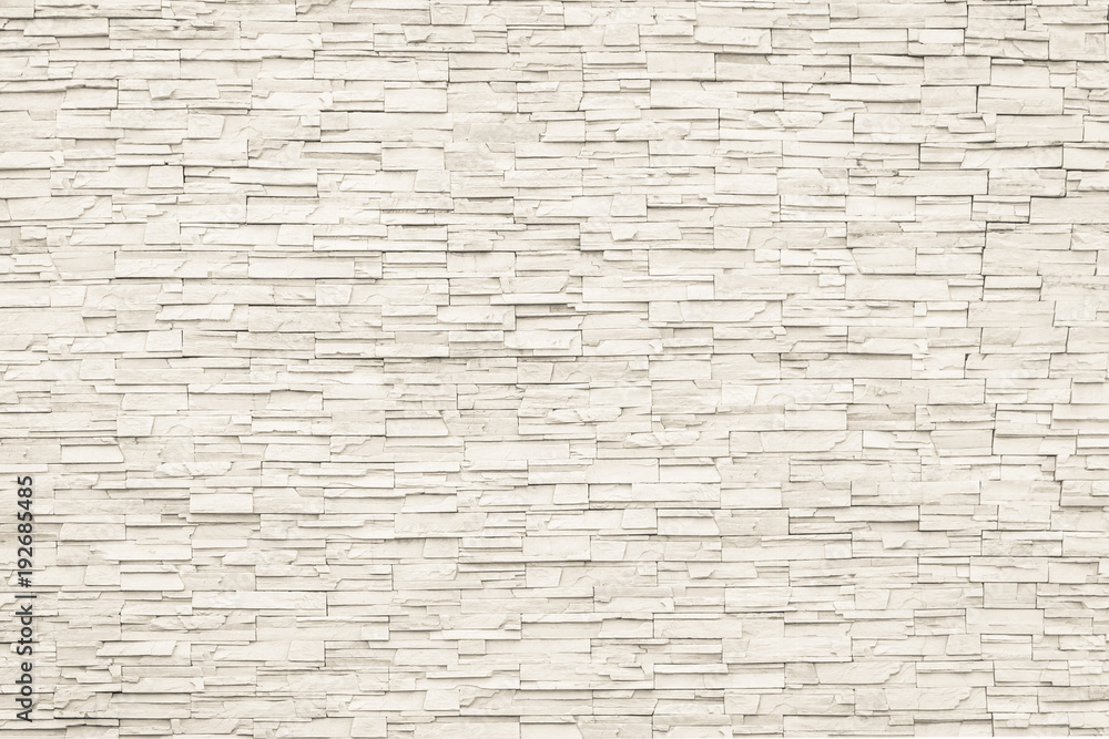 Obraz premium Rockowa kamienna cegły płytki ściana starzał się tekstury szczegółowego deseniowego tło w kremowym beżowym brown kolorze