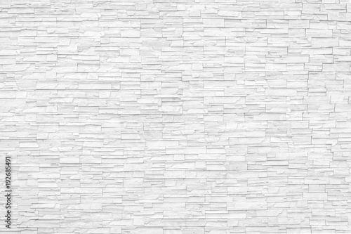 Rock stone brick tile wall aged texture detailed pattern background in cream beige brown color © Chinnapong