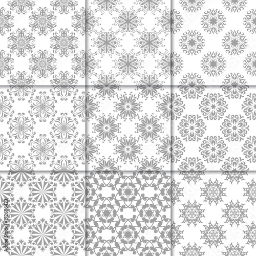 Gray and white floral ornaments. Collection of seamless patterns