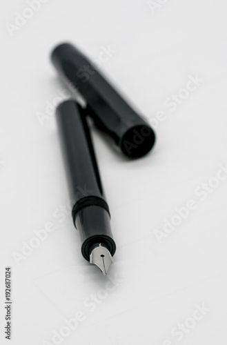 Black fountain pen with silver nib isolated on white