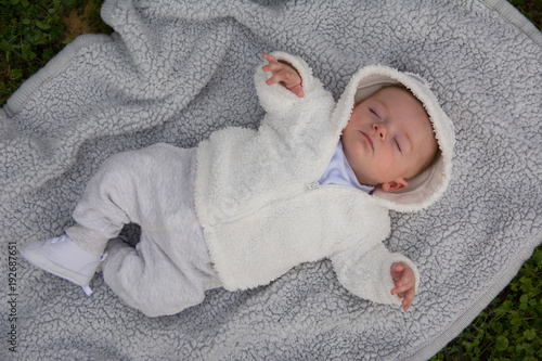 Cute baby lying on the pillow in the park