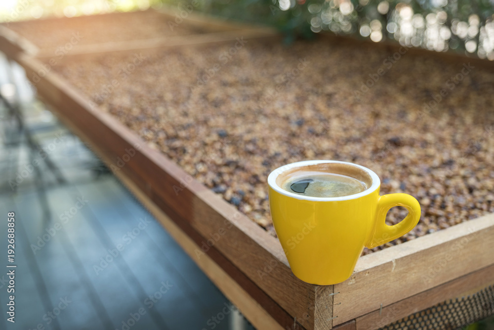 Yellow coffee mug with honey process coffee blurred background. Yellow coffee mug with honey process coffee blurred background.