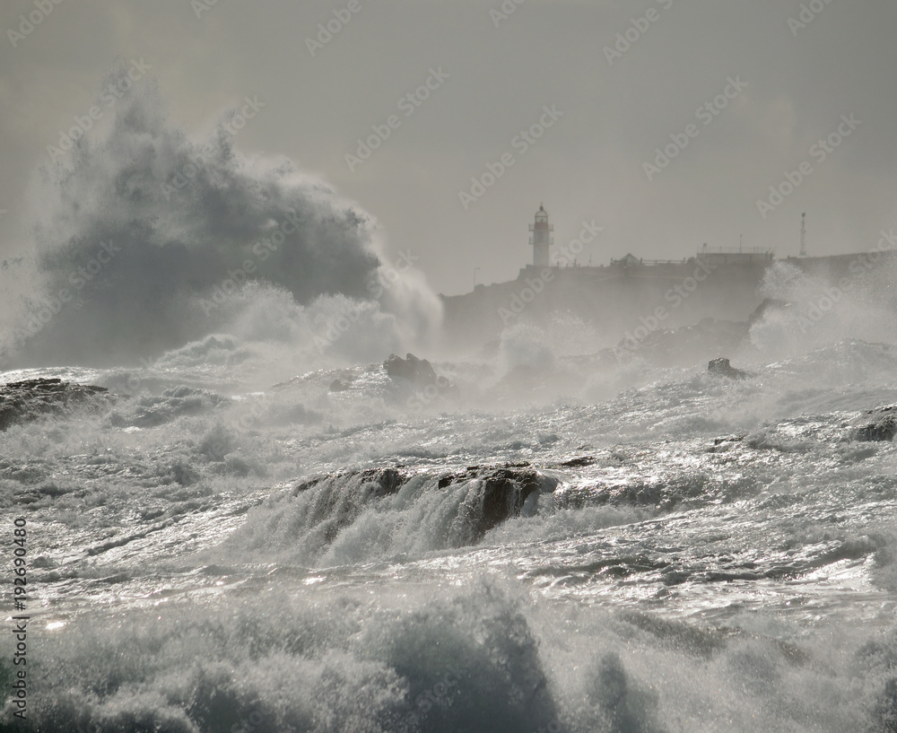 Rough sea on the coast, big waves and lighthouse, La Garita, Gran canaria, Canary islands