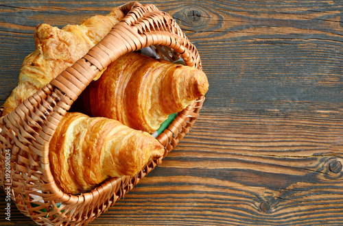 Photography Corissants in the basket on wooden background