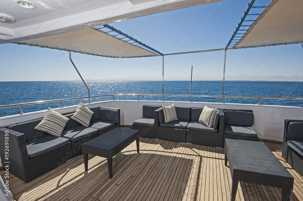 Fototapeta premium Table and chairs on deck of a luxury motor yacht