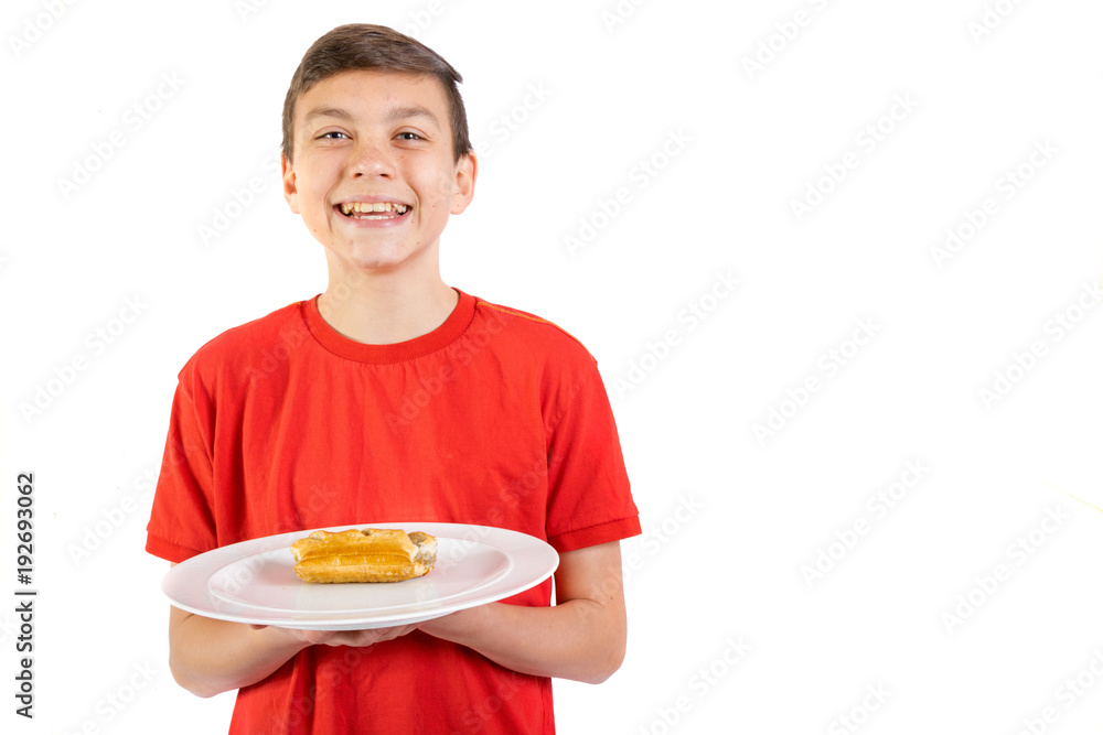 Young caucasian teenage boy with a sasauge roll Young caucasian teenage boy with a sasauge roll
