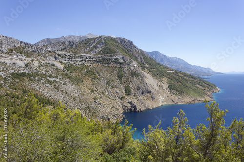 Dalmatian coastline with its cliff and streets through mountains, by the sea